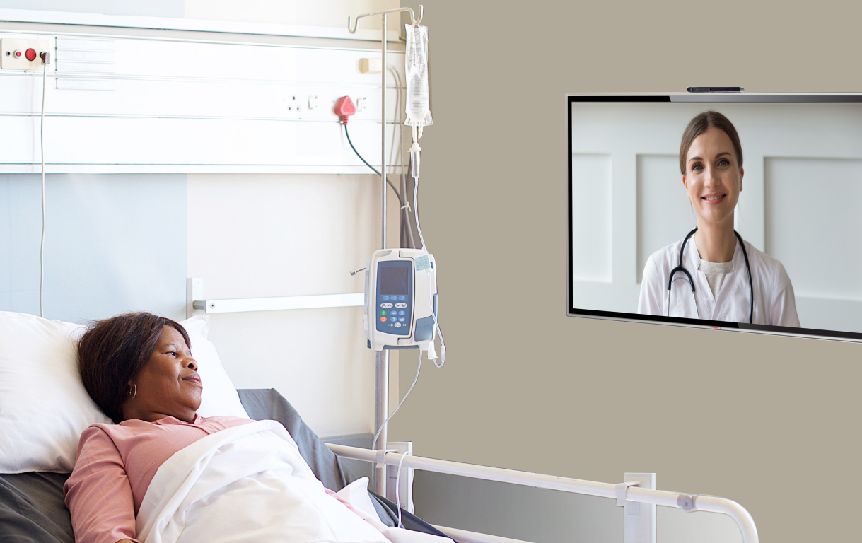 patient in the hospital bed talking to a doctor via TV Kit