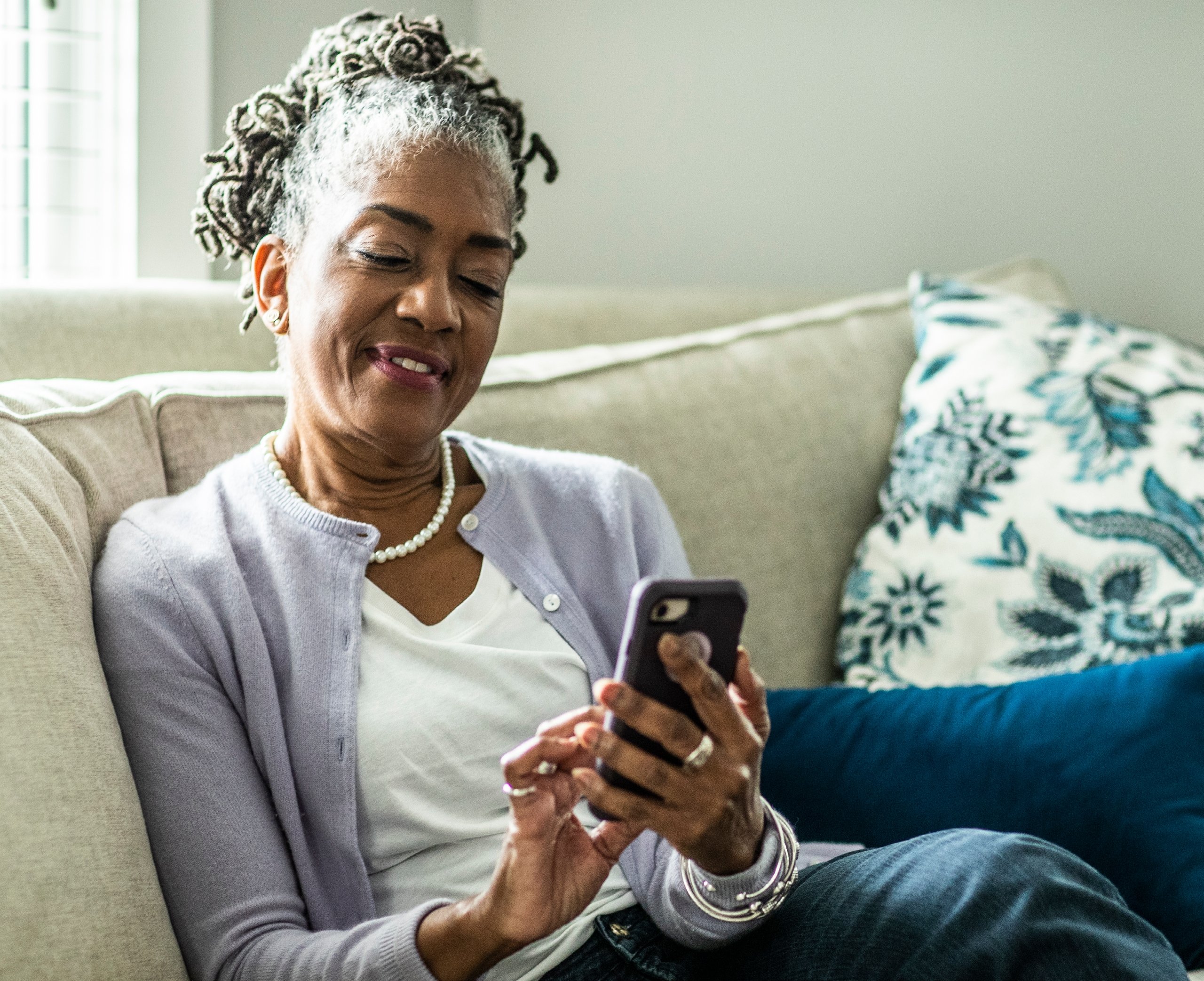 african-american female patient on her phone using automated care