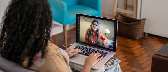 patient at home talking to a provider on her laptop