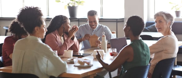 people at work eating a lunch together