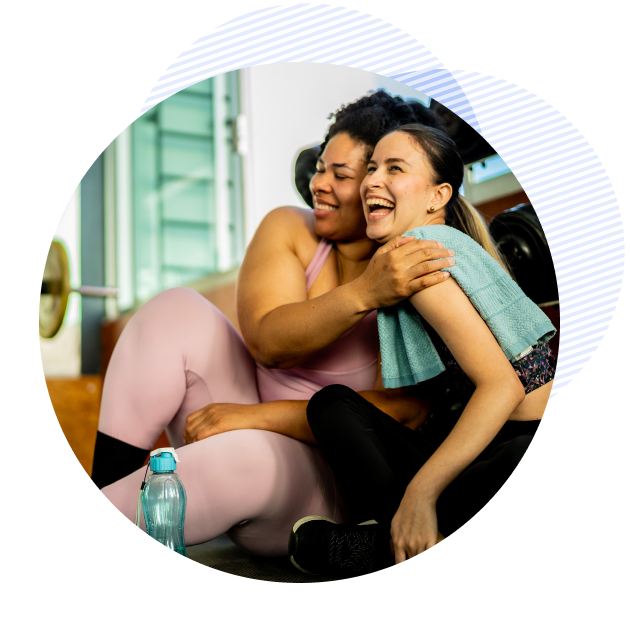 vida two women at the gym exercising and laughing