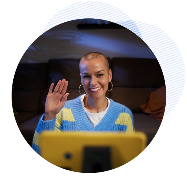 a female patient waving to her therapist on her laptop