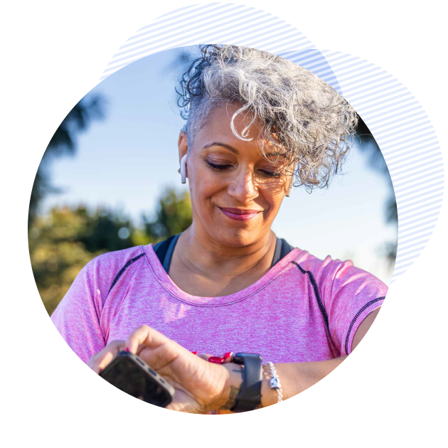 patient using her smart watch and holding her phone