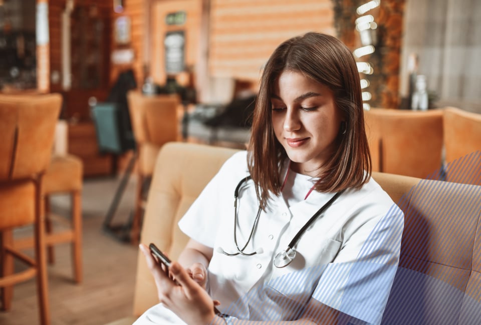 young doctor looking at her phone