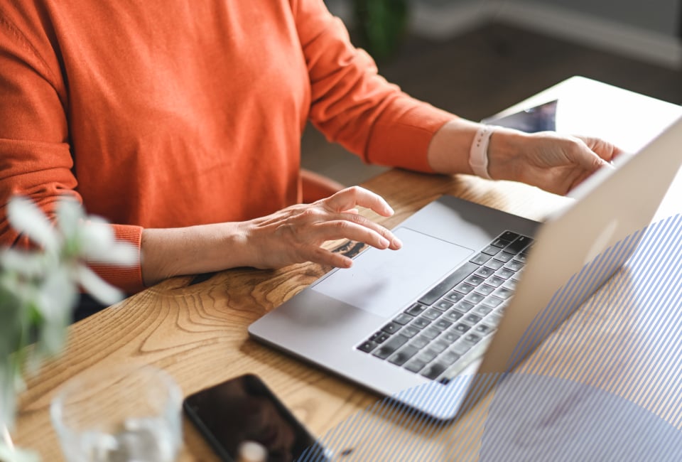 a person at her desk connecting with a therapist via laptop