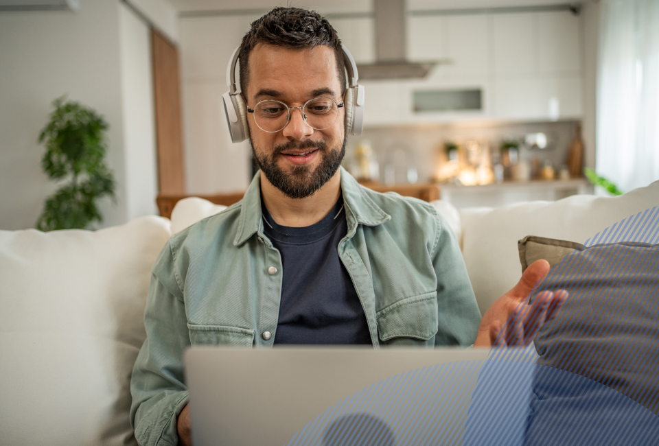 patient with a headphones talking to a provider on his laptop
