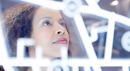 a woman with a curly hair looking in some kind of technology