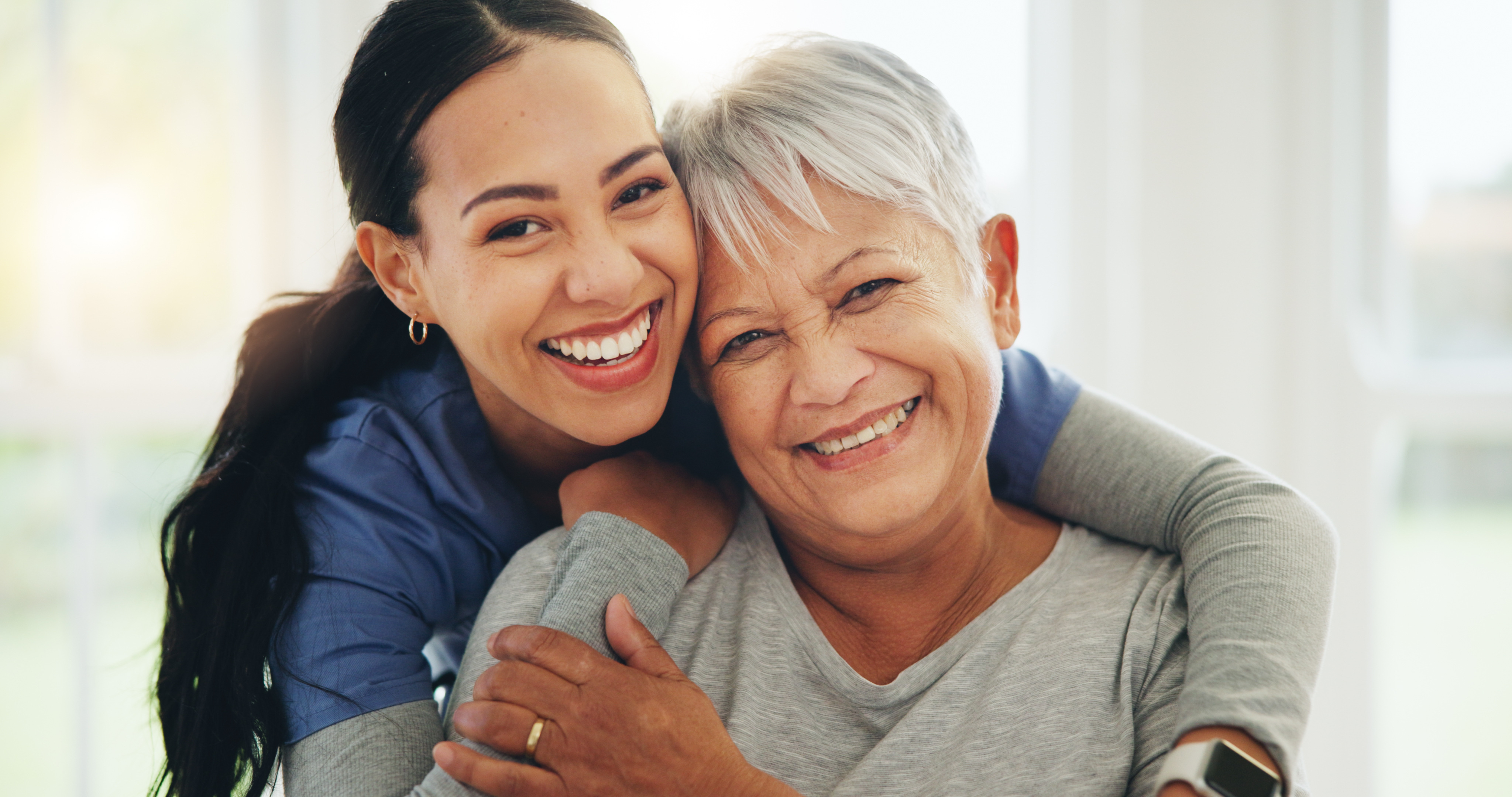 a nurse hugging a patient they look happy
