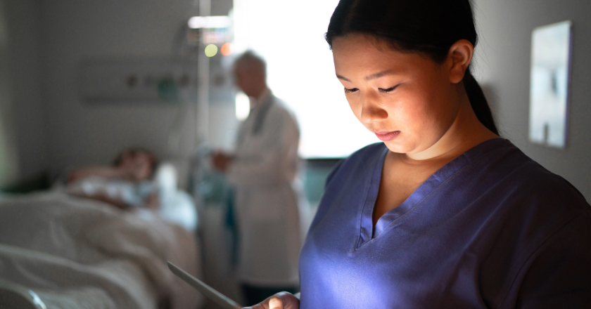 asian young nurse in the hospital looking at the device