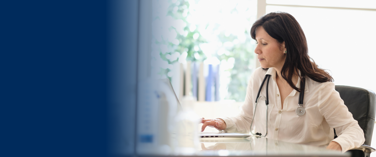 doctor typing on her laptop desktop